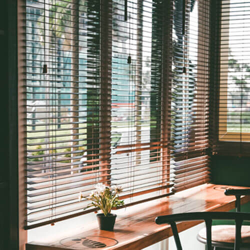 Timber Blinds, like those offered by The Blind Shop, in a sunny canberra cafe 