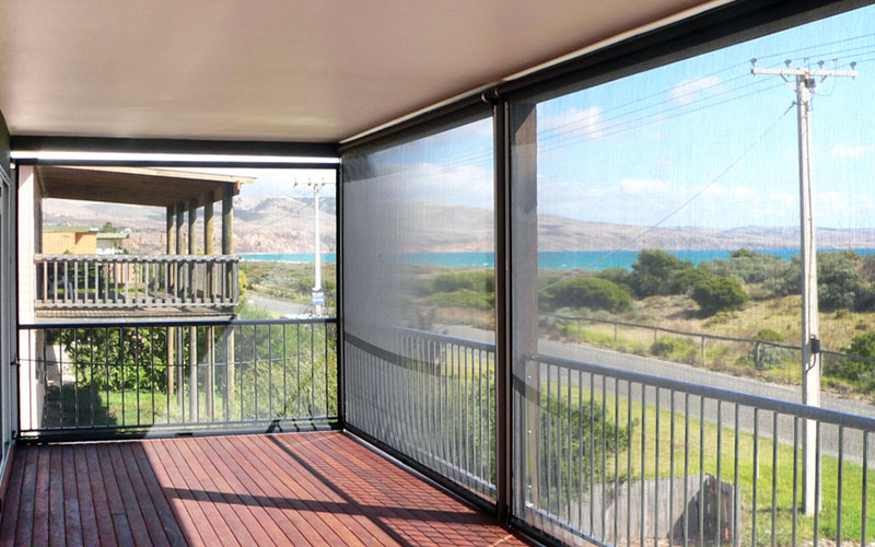 Ziptrak blinds protecting a balcony. Install yours from The Blind Shop today.